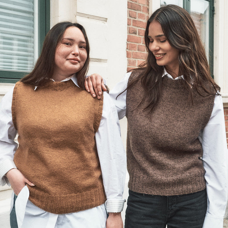 Two women wearing the Knitting for Olive Olive's Vest slipover over white shirts