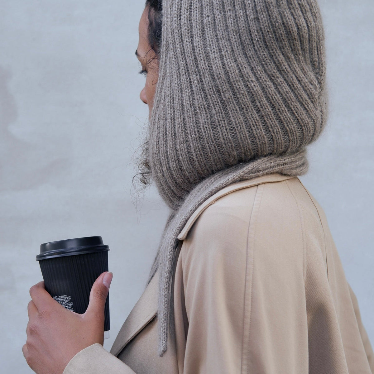 Woman wearing the Knitting for Olive Alex Hood with the hood pulled up over her head