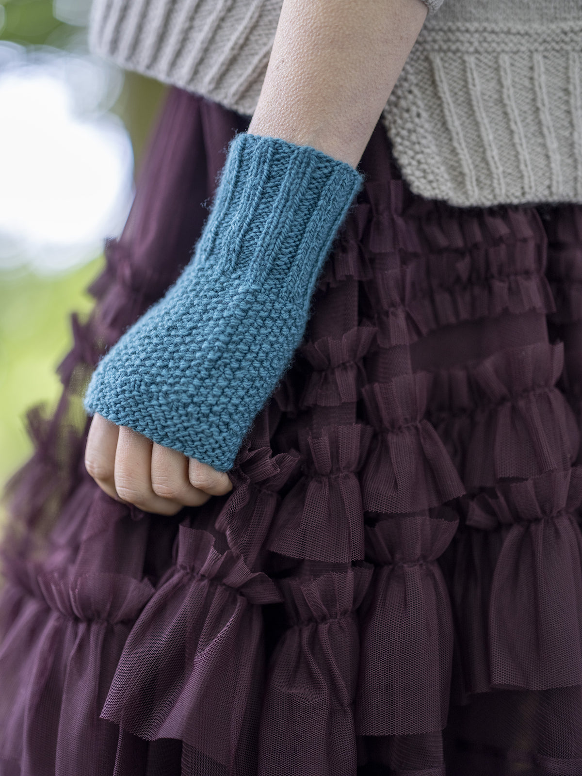 The Maybole Mittens worn, showing the thumb opening and garter stitch edge.